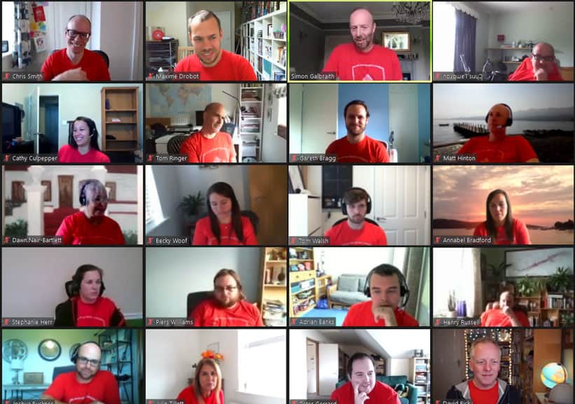 A group of people on a Zoom call in matching red t-shirts