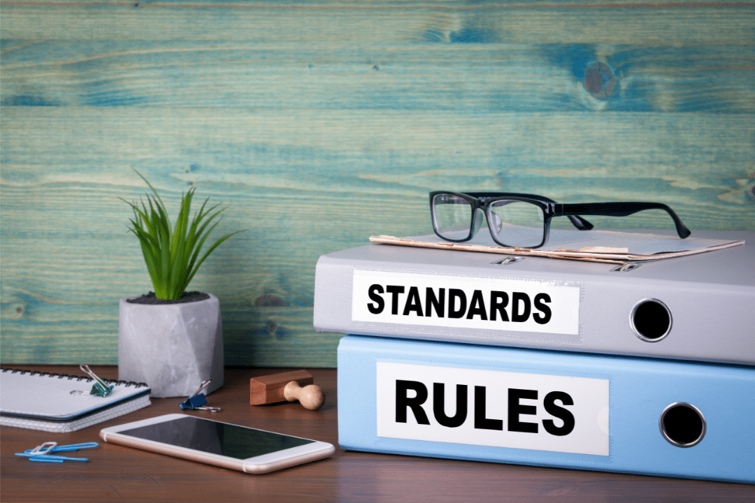 A typical study table that contains folders standards and rules stacked on top of each other