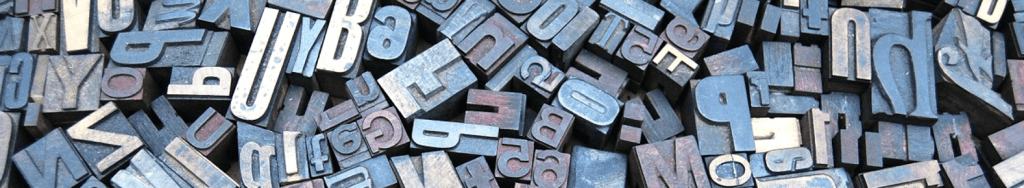 A pile of metal letters Description automatically generated