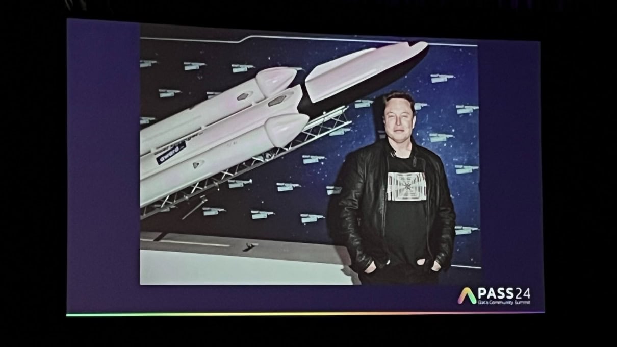 A person standing in front of a rocket

Description automatically generated
