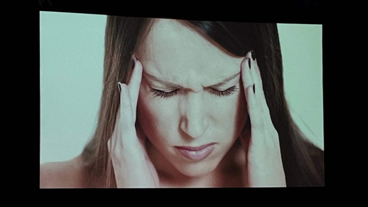A person with her hands on her head

Description automatically generated