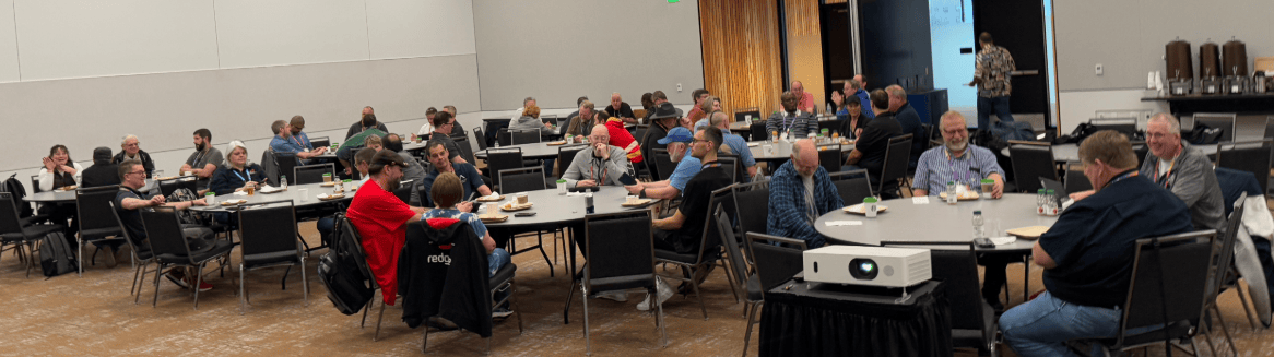 A group of people sitting at tables
Description automatically generated